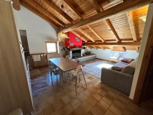 a living room with a table and a couch at Baita del Canton in Valdidentro