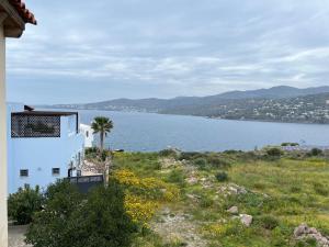 a view of a large body of water from a house at Perdika's Nest, family friendly house by the sea in Perdhika
