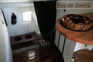 a small kitchen with a wooden bowl on a table at Logements Chaîne des Puys avec garages attenants in Clermont-Ferrand
