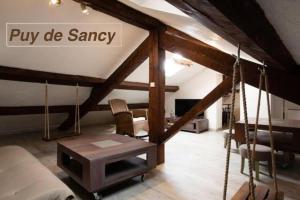 a living room with a swing in a attic at Logements Chaîne des Puys avec garages attenants in Clermont-Ferrand