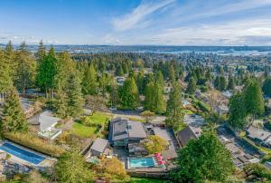 an aerial view of a home with a pool and trees at Grouse Cheerful large private bedroom, bath, shared deck, pool, hot tub in North Vancouver