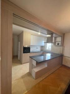 a kitchen with a large island in the middle at Apartments in villa Sabb for rent in Sarajevo
