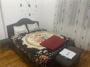a small bedroom with a bed and a chair at Iliovski Inn - Just Like Home in Prilep