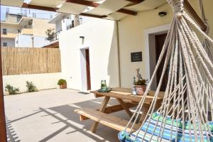 a hammock on the patio of a house at Raeti Cretan Guesthouse in Moírai
