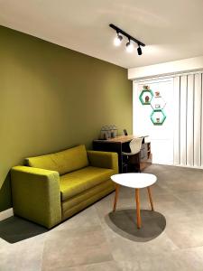 a living room with a yellow couch and a table at Uranus Studio in Piatra Neamţ