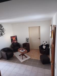 uma sala de estar com cadeiras, uma mesa e um urso panda em DYNAMIQUE ET SPLENDIDE em Bourgoin-Jallieu