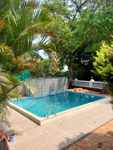 a swimming pool in a yard with trees at Dream House Mahabaleshwar in Mahabaleshwar