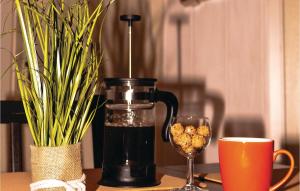 a coffee maker on a table next to a glass at Two-Bedroom Holiday Home In Middelhagen in Alt Reddevitz +10 photos