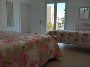 a bedroom with a bed and a couch and a window at Da Raff in Lacco Ameno