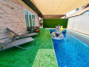 a swimming pool with a zebra in the middle of it at Midas Pool Villa in Jomtien Beach