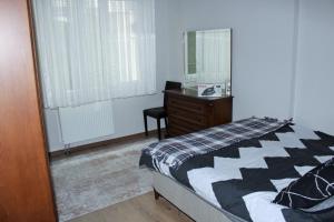 a bedroom with a bed and a desk and a mirror at Roni in Esenyurt