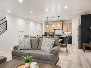 a living room with a couch and a kitchen at Lula Inez Game Paradise townhouse in Atkinville +57 photos