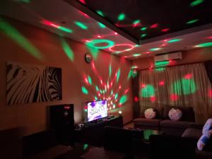 a room with a couch and a tv with green lights at Midas Pool Villa in Jomtien Beach +63 photos