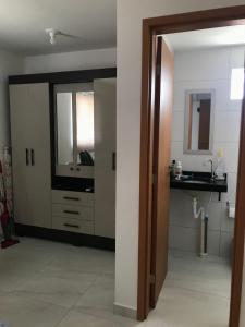 a bathroom with a sink and a mirror at Lindo apartamento de férias à 100m do mar! in Cabedelo