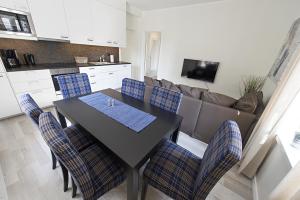 a kitchen and dining room with a table and chairs at Townhouse Apartments in Mariehamn