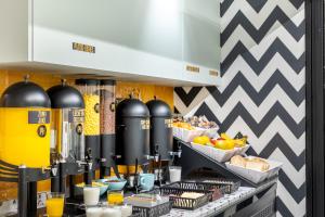 a breakfast buffet with food and drinks on a counter at Petit Hostel Palacio Real in Madrid