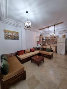 a large living room with couches and a kitchen at Appartement vue mer in Mahdia