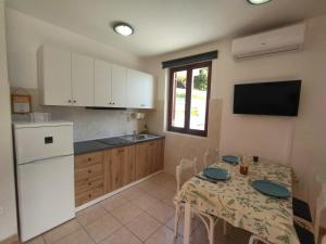 a kitchen with a table and a kitchen with white appliances at Apartment Rosanna - Intermezzo in center of Rabac in Rabac +78 photos