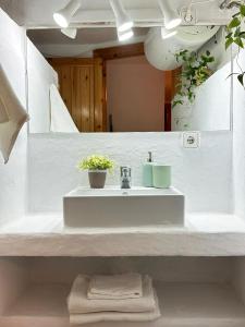 a white bathroom with a sink and a mirror at Duplex Son Parc Best Sea Views in Son Parc
