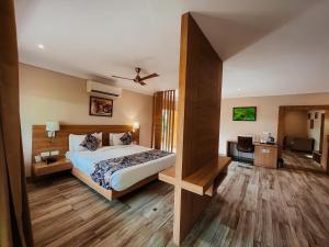 a bedroom with a bed and a desk in a room at DESI THATH RESORT in Alwar