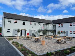 a building with tables and chairs in the courtyard at Park Head Hotel in Bishop Auckland