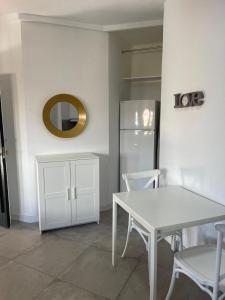 a kitchen with a white table and a refrigerator at 180 Home. Rincón de Triana in Seville