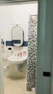 a bathroom with a sink and a mirror at Le Chicche del Porto Riviera in Genova
