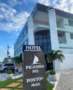 a hotel with a sign in front of a building at HOTEL KICHARME PONTAL in Fortim