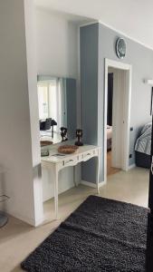 a room with a white desk and a mirror at Le Chicche del Porto Riviera in Genova