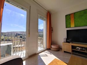 ein Wohnzimmer mit einem TV und einem großen Fenster in der Unterkunft Apartment-in-turre-andalucia in Turre