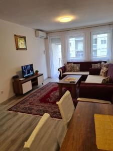 a living room with a couch and a table at Fush Kosov Apartment Center in Kosovo Polje