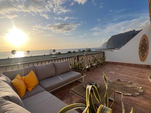 a living room with a couch and a view of the ocean at My Ocean - Cliff & Ocean View in Acantilado de los Gigantes