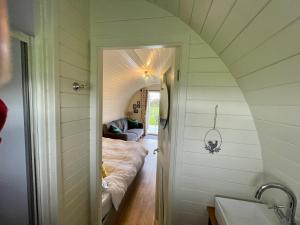 an attic room with a bed in a room at Abbey farm luxury glamping in Rhuddlan