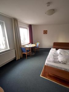 a hotel room with a bed and a table at Hotel Granitz in Binz