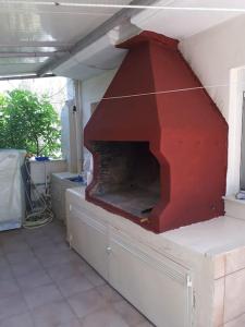 a fireplace in a house with a red wall at Shadow of Olympus in Olympic Beach