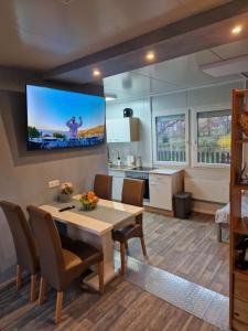 a kitchen and dining room with a table and a tv at La Casita del Pueblo 