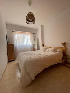 a bedroom with a large bed and a window at Casa cactus Piles Playa in Piles