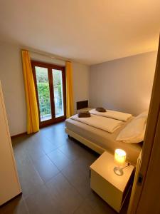 una camera con due letti e una finestra di Marenca Residence a Cannobio