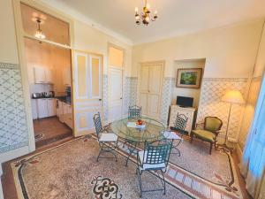 a living room with a glass table and chairs at Résidence La Villa Léonie in Nice