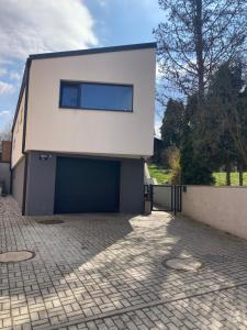 a building with two garage doors on the side of it at Nerudovka apartment in Karlovy Vary