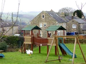 a playground with a slide and a swing set at North Farm in Hexham
