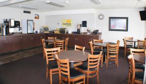 a dining room with wooden tables and chairs at Days Inn by Wyndham Sioux Falls in Sioux Falls