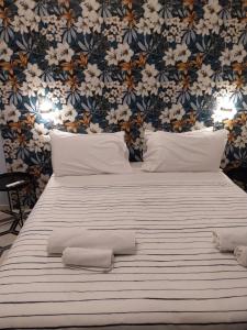 a bedroom with a large bed with two towels on it at Firenze32 in Naples