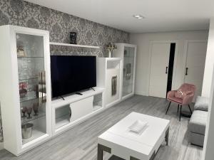 uma sala de estar com uma televisão de ecrã plano em Apartamento Maitika em Santander