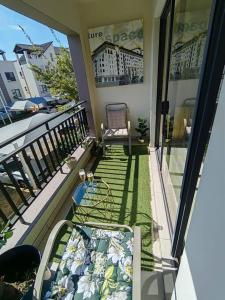 a balcony with a bed and a view of a building at Classy and cosy Apt - Dainfern in Fourways