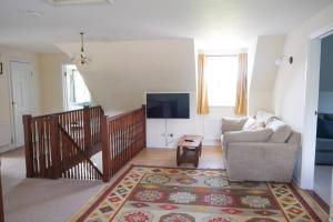 a living room with a couch and a tv at Spacious North Devon villa with beautiful garden in Bideford