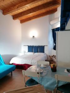 a bedroom with a bed and a blue couch at Petronilla in Fermo +16 photos