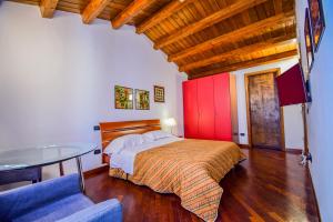 a bedroom with a bed and a table in a room at Case Ruggero in Cefalù +7 photos