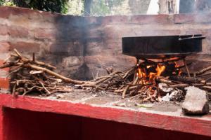 a grill with a pile of sticks and fire at Cabañas Las Sirenas in Mar del Plata