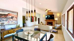 a living room with a dining table and a fireplace at San Angel Villas in San Antonio